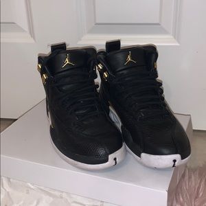 Black and gold Jordan 12s